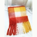Close-up detail of orange and yellow checkered scarf with soft tassel fringe edges - Orange