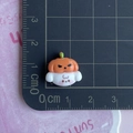 Miniature resin pumpkin ghost charm shown on a centimeter scale ruler for sizing detail - Pumpkin Ghost Dog