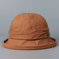 Detail view of high-quality rust brown linen bucket hat for women showing fabric texture - M (56-58cm) / Orange