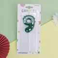 Green dinosaur number 9 birthday candle with white dots in blister card packaging - Green Dinosaur Number 9