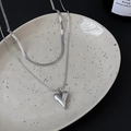 Minimalist double layer silver heart necklace with flat snake chain on a gray plate - Stacked Heart Necklace Set / Silver Double-layer Layered Necklace