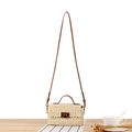 Beige woven straw crossbody bag with brown leather strap and gold metal lock detail - Beige