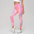 High-waisted seamless yoga leggings featuring a colorful pink and blue gradient tie-dye pattern - Cai Sunset Red