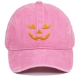 Close-up of orange pumpkin face embroidery on a pink washed cotton baseball cap - One Size / Pink