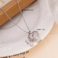 Silver heart pendant necklace with zircon inlay on a white plate, 40cm plus 5cm length - Silver Wrapped Heart