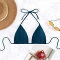 Flat lay of navy blue halter bikini top with strings on marble background with beach props - Dark Blue
