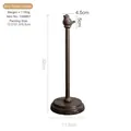 Vintage bronze cast iron paper towel holder with bird decorative top standing on white base - Tailed Bird Holder