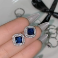 Square silver stud earrings featuring a blue center stone with a double halo of white diamonds - Blue Diamond Large Square Earrings Tz-40
