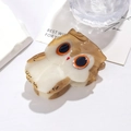 Detailed close-up of a brown acetate owl hair claw clip with a glossy marble texture - Cute Owl