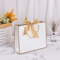 White paper gift bag with gold trim, gold satin bow decoration, and woven handles - 28*20*10cm / White with Gold Edge + Gold Ribbon