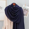 Detail of a navy blue cotton linen scarf draped over a suit for a breathable summer look - Navy Blue