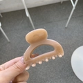 Close-up of a glossy cream-colored square hair claw clip with a strong spring hinge - Deep Nude Pink