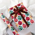 DIY cartoon gift wrapping paper with colorful ladybug patterns and decorative gift box - Ladybug
