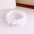 Close-up of translucent white acrylic bangle featuring a unique wavy scalloped edge design - Clear White