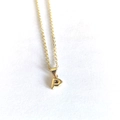 Detailed view of tiny gold letter P pendant on fine cable chain for minimalist styling - Letter P