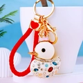 Detail of white duck keychain with gold crown and sparkling rhinestones on woven rope - Red Rope + White Duck