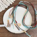 Détail d'un collier bohème multicouche avec perles oeil de tigre et breloques en forme de coeur - Style 19