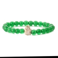 Macro detail of elastic bracelet with green beads and a white elephant charm - Green Chalcedony