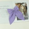 Handmade purple plaid bow hair clip on a stylish magazine background - Purple