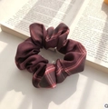 Elegant deep wine red plaid organza scrunchie on an open vintage book page - Wine Red Classic Plaid