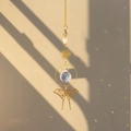 Macro detail of brass butterfly crystal suncatcher showing light refraction and shadows - Long Tail Butterfly
