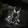 Handmade branch earrings with blue and green gemstones on textured dark vase - Blue/Yellow-Green (C)