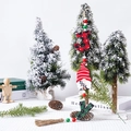 Nahaufnahme der Holzperlen Girlande mit Weihnachtswichtel und rustikalen Quasten - Zwerg mit rotem Hut