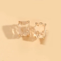 Detail view of emerald cut square crystal earrings with golden four-prong setting - White (Gold)