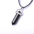 Macro detail of hexagonal black obsidian crystal pendant with silver clasp and leather cord - Black Agate