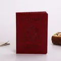 Dark red faux leather US passport cover with embossed gold seal and premium stitching - Burgundy