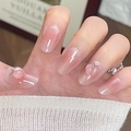 Pink gradient press-on nails with 3D peach charms and shimmer finish on hand - By2190 Graceful And Elegant / Phototherapy Glue Style