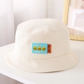 Dettaglio cappello pescatore panna per bambini con patch sorriso in silicone blu - 52cm / Beige