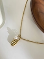 Detailed shot of golden shell pendant with pearl on delicate stainless steel bead chain - Cowrie Shell