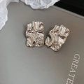 Macro shot of silver square stud earrings with liquid metal texture and wrinkled design - Silver (Silver Pin)
