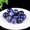 Set of 10 blue cat eye stone spheres with white marble patterns in a white bowl - Blue Sodalite