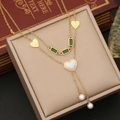 Detail of emerald gemstone and gold heart pendants on double-layered necklace - 2# Heart Shell Style