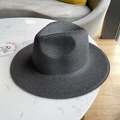 Classic dark grey woven straw fedora hat for sun protection on a marble surface - Black