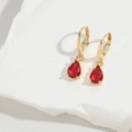 Detailed view of red pear-shaped gemstone earrings on a white stone background - Red(ES2722-2)