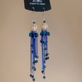 Detail view of gold boho tassel earrings with deep blue beads and long chain fringe - Crown Hollow Ball Tassel Style / Gold-Blue Hook Style