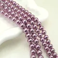 Macro detail of glossy purple round imitation pearls for DIY jewelry making and crafts - Royal Purple (no. 15) / Approximately 200 Pieces Per Strip 4mm In Size.