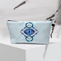 Detail of light blue Evil Eye makeup bag with geometric patterns and black zipper closure - Light Blue Geo Design