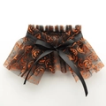 Detail of Halloween pet collar with pumpkin prints on black mesh and a satin ribbon bow - S (For Cats & Small Dogs) / Pumpkin Orange