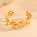 Detailed close-up of a gold hollow tree of life bangle with intricate shadow patterns - Gold Tree Of Life Hollow Style (G419)