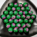 Macro shot of polished green zoisite and ruby crystal spheres on a black triangular tray - 25mm No Hole Sphere / Ruby Zoisite