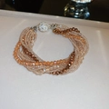 Detail of multi-strand beaded necklace with champagne crystals and crystal magnetic clasp - Multi-strand Braided Bracelet / Brown