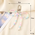 Handmade beaded bow charm with pink and blue beads featuring a silver spring clasp - Colorful Seed Bead Bow Keychain