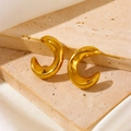 Detailed view of polished thick C-shaped gold hoop earrings on a natural stone base - C-Shape Smooth Thickened Stud Earrings Gold (F603)