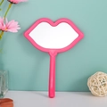 Lip-shaped handheld makeup mirror in vibrant pink with smooth plastic handle - Rose Red