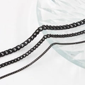 Three sleek black stainless steel Cuban link chains of various thicknesses on glass plate - 3mm/48cm / Black
