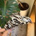 Detail of large acetate hair claw clip featuring black and white marble ink patterns - Large / Cream Black Coffee